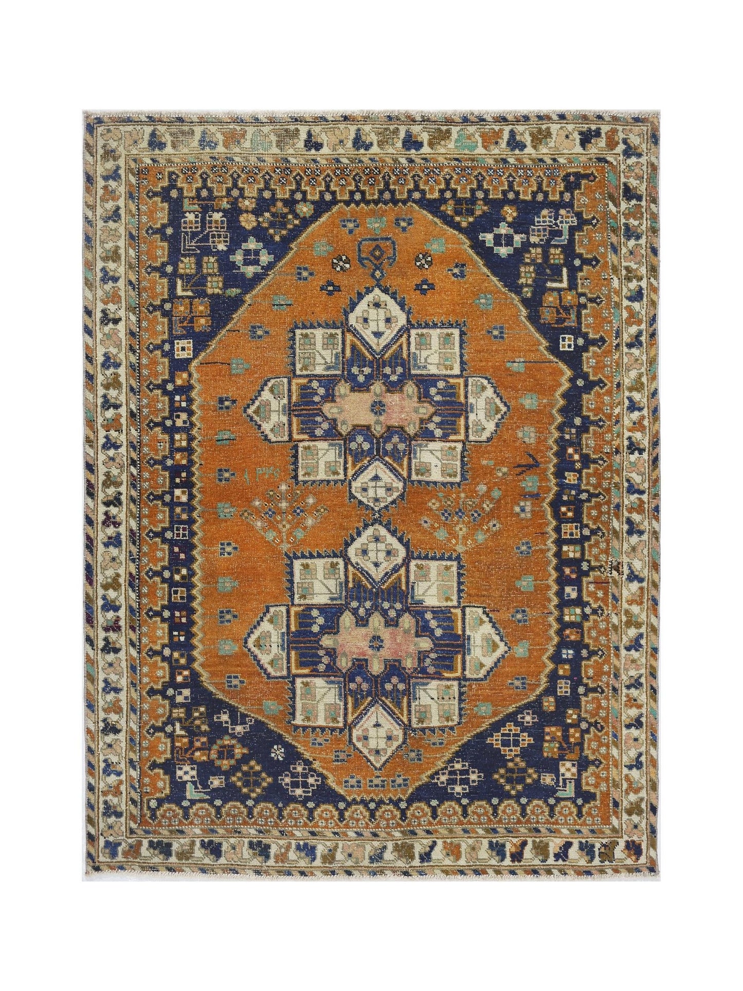 A vintage handmade Persian rug featuring a geometric blue and orange medallion pattern.