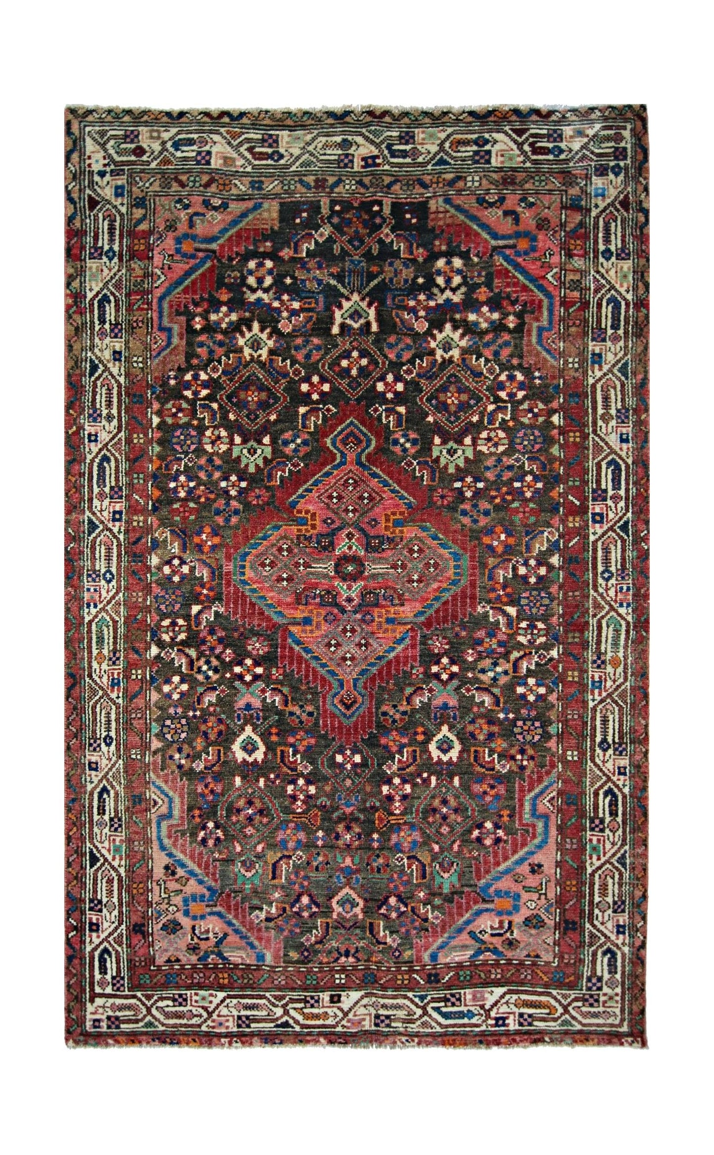 A vintage handmade Persian rug featuring a central geometric medallion on a dark floral field.
