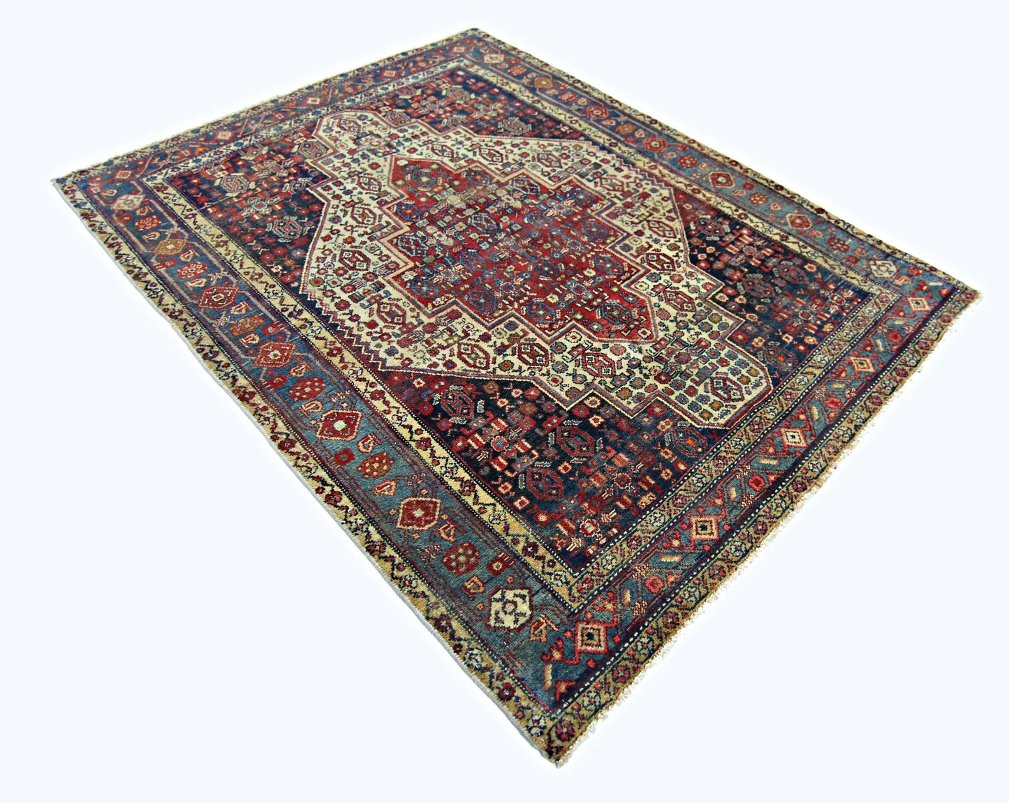 A rectangular vintage Persian rug featuring a central medallion with intricate red and blue patterns.