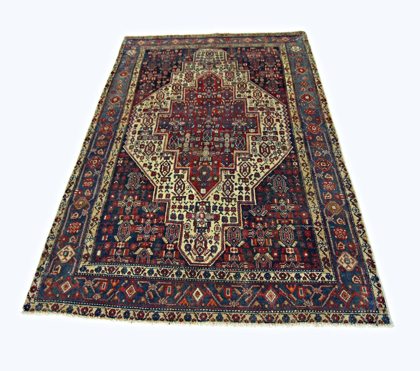 A rectangular vintage Persian rug featuring a central medallion pattern in red, blue, and cream.