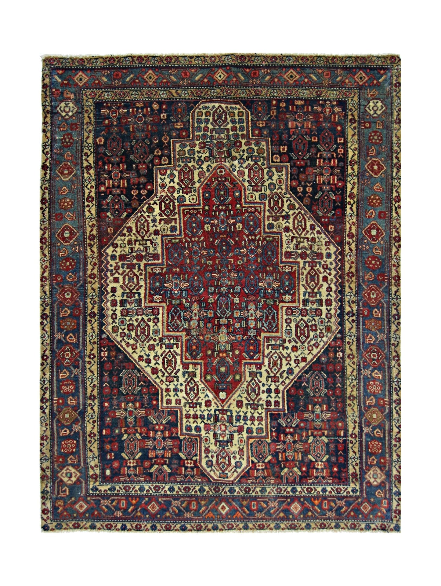 A vintage handmade Persian rug featuring a central geometric medallion on a dark blue background.