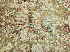 A close-up of a vintage Persian rug featuring intricate floral patterns in muted earth tones.