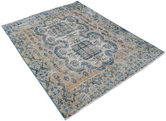 A vintage Persian rug featuring a blue and tan geometric pattern on a distressed wool pile.