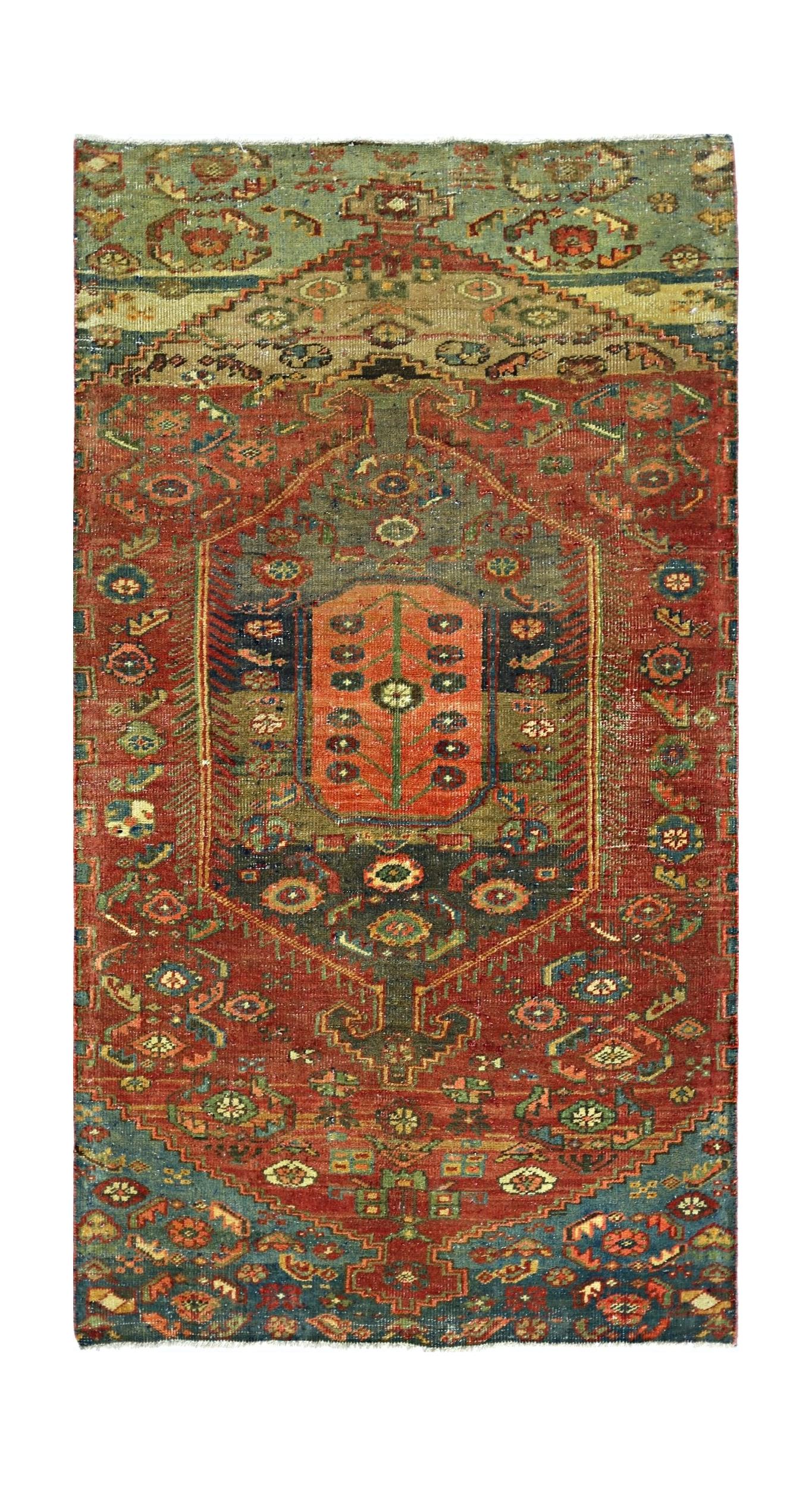 A handmade vintage Persian rug featuring a central medallion with intricate floral patterns in red and blue.
