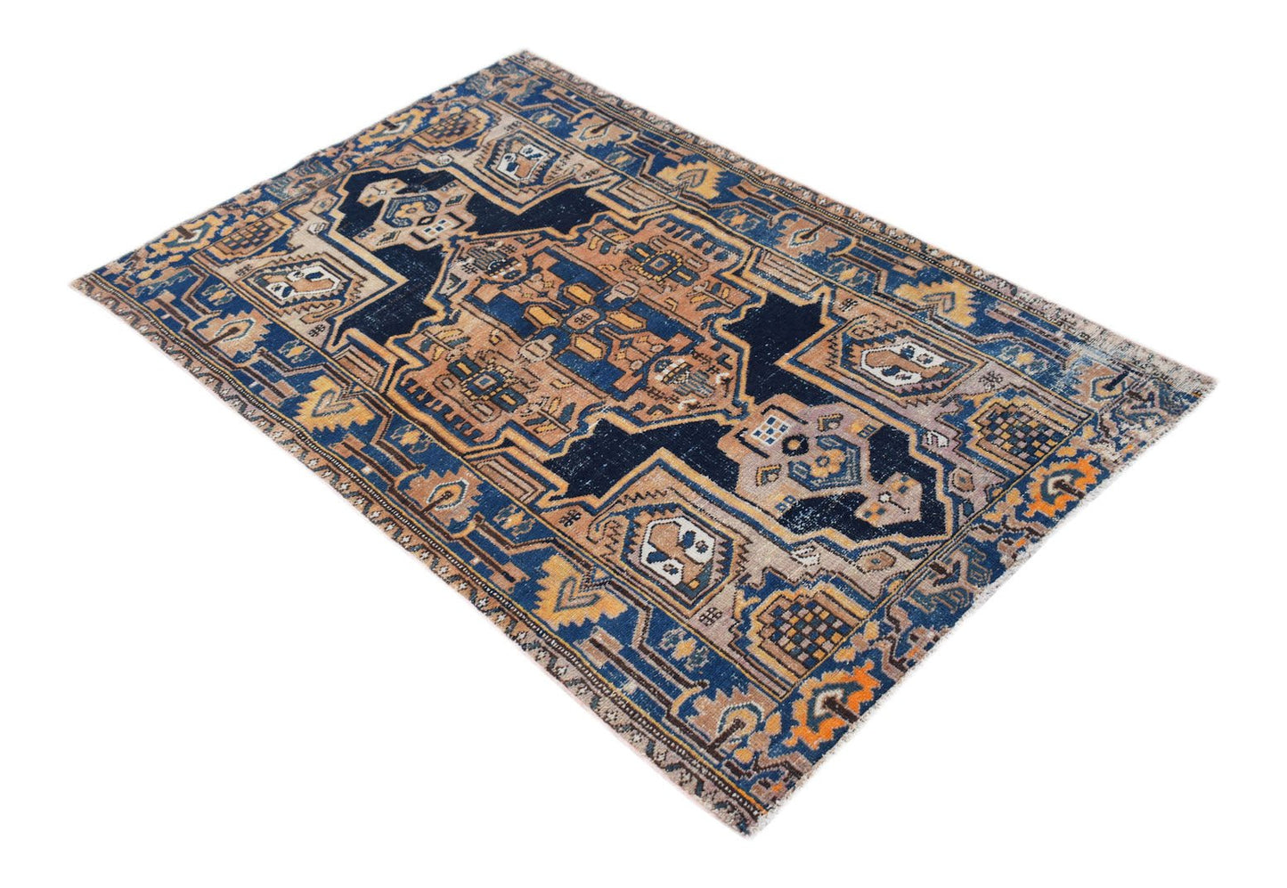 A handwoven vintage Persian rug featuring a geometric pattern in shades of blue, tan, and orange.