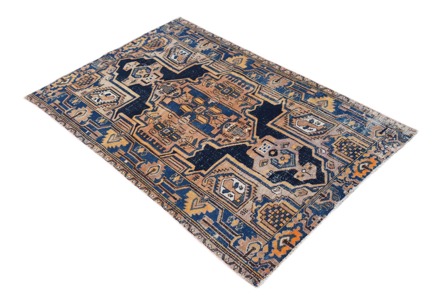 A handwoven vintage Persian rug featuring a geometric pattern in shades of blue, tan, and orange.