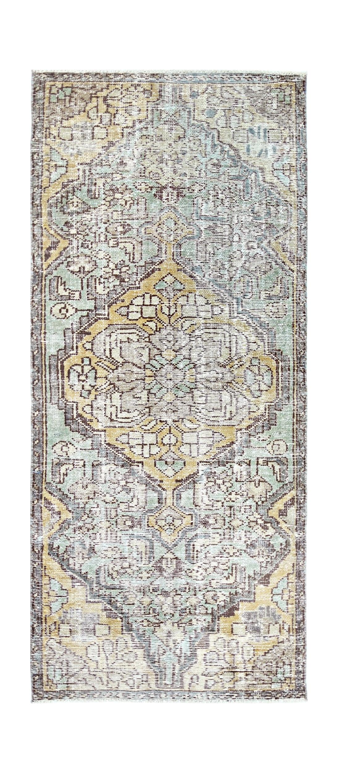 A vintage Persian runner rug featuring a faded geometric medallion in shades of blue and gold.