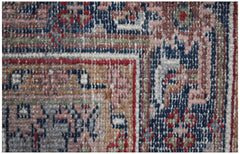 A close-up view of a vintage Persian rug featuring intricate geometric patterns in wool.