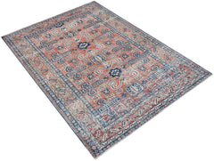 Vintage Persian rug with intricate coral and blue geometric patterns.