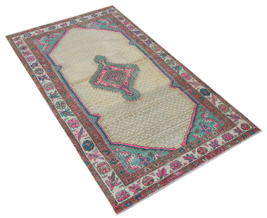 A vintage handwoven Persian rug featuring a central geometric medallion on a cream field.
