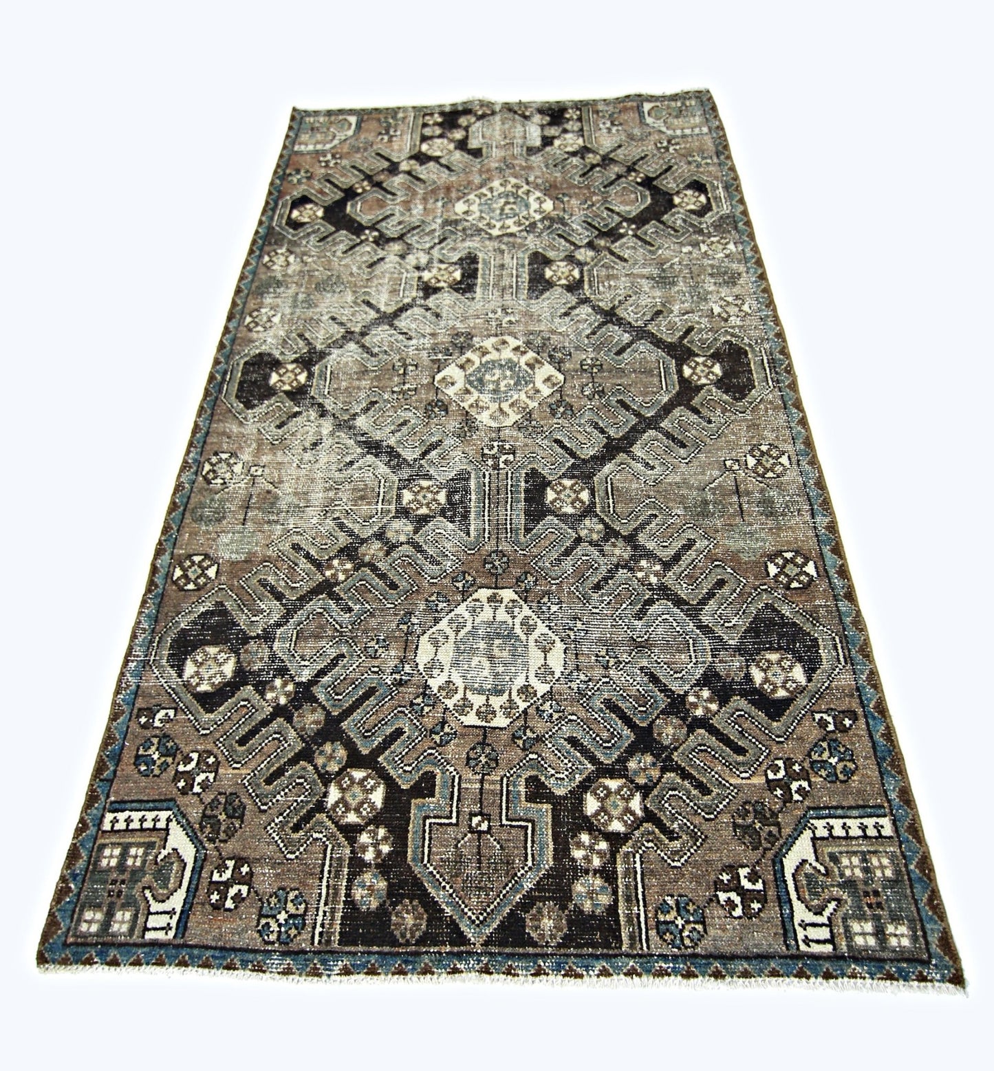 A handmade vintage Persian rug featuring a geometric pattern in shades of brown, blue, and cream.