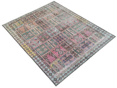 A vintage Persian rug featuring a patchwork design with faded geometric patterns in muted colors.