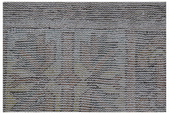 Vintage Persian rug with a textured, striped pattern in muted colors.