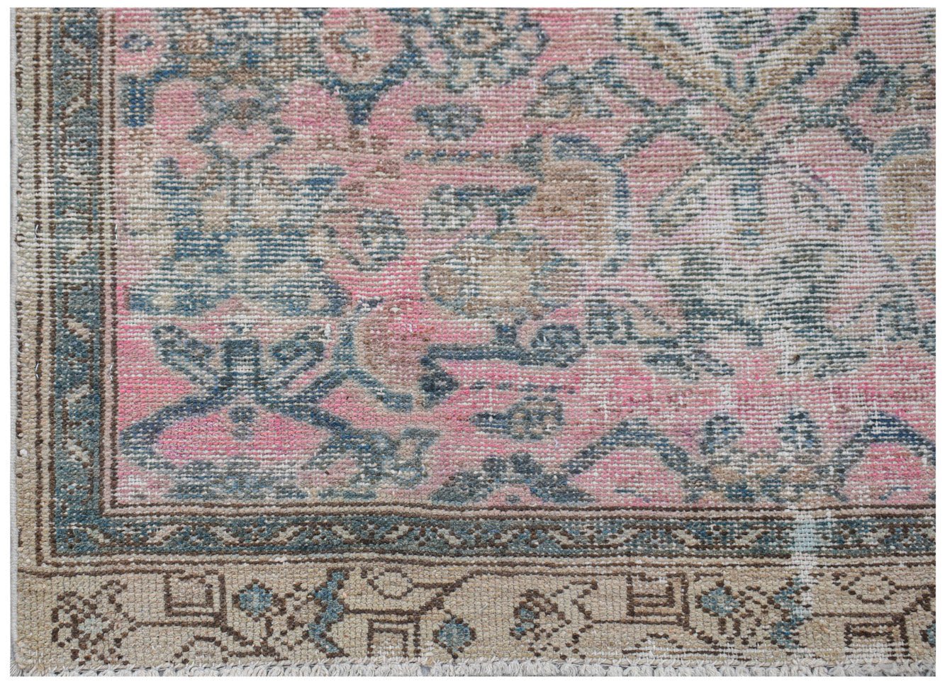 Vintage Persian rug with pink, blue, and tan floral patterns.