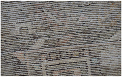 A close-up view of a handwoven vintage Persian rug featuring a textured, distressed wool pattern.