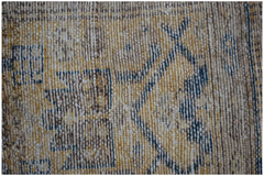 A close-up view of a handwoven vintage Persian rug featuring a faded geometric pattern in wool.