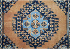 A vintage handwoven Persian rug featuring a geometric blue and orange medallion pattern.