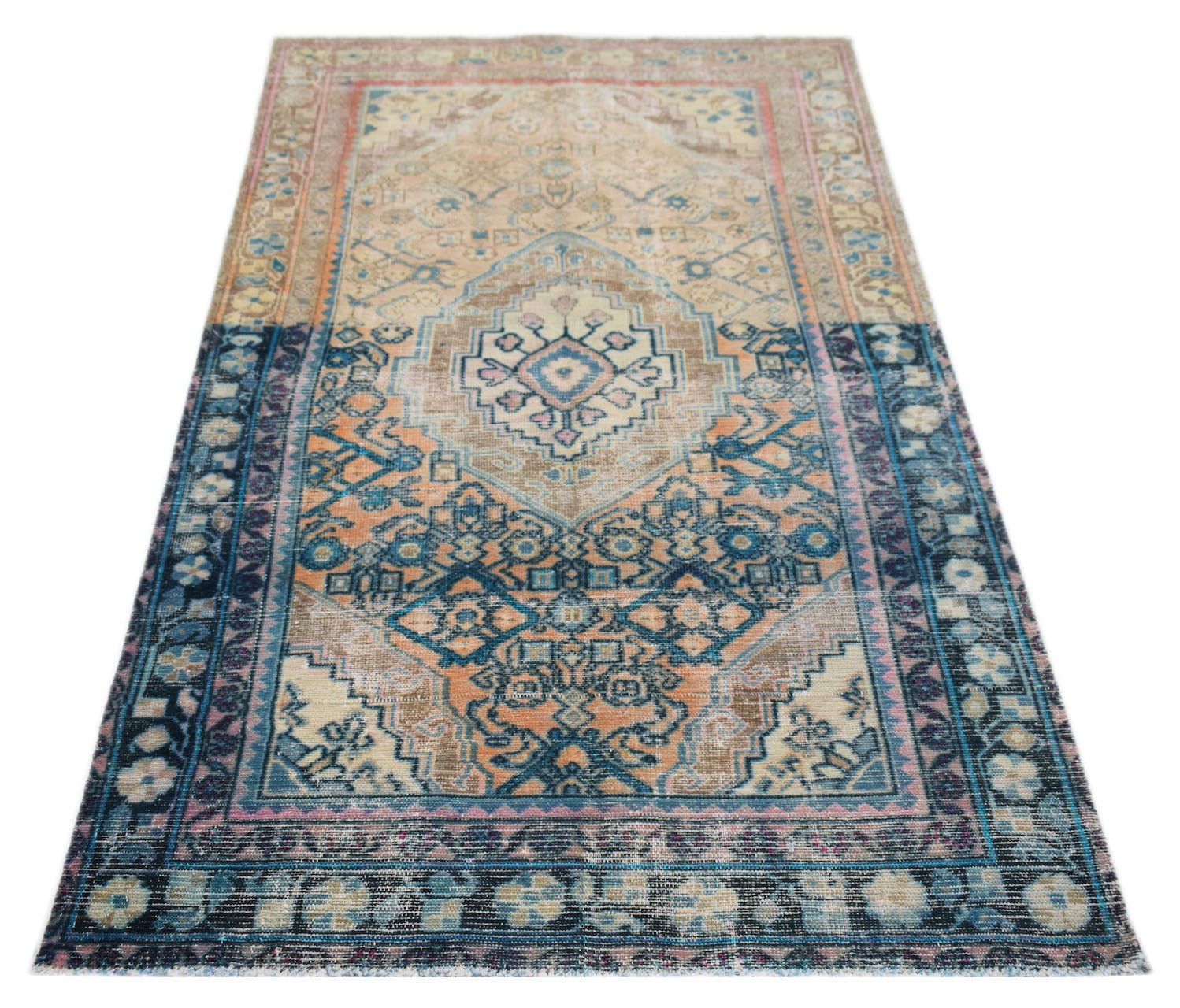 A vintage handwoven Persian rug featuring a central medallion in shades of blue, orange, and beige.