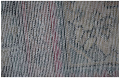 A close-up view of a vintage Persian rug showing intricate handwoven wool patterns and textures.