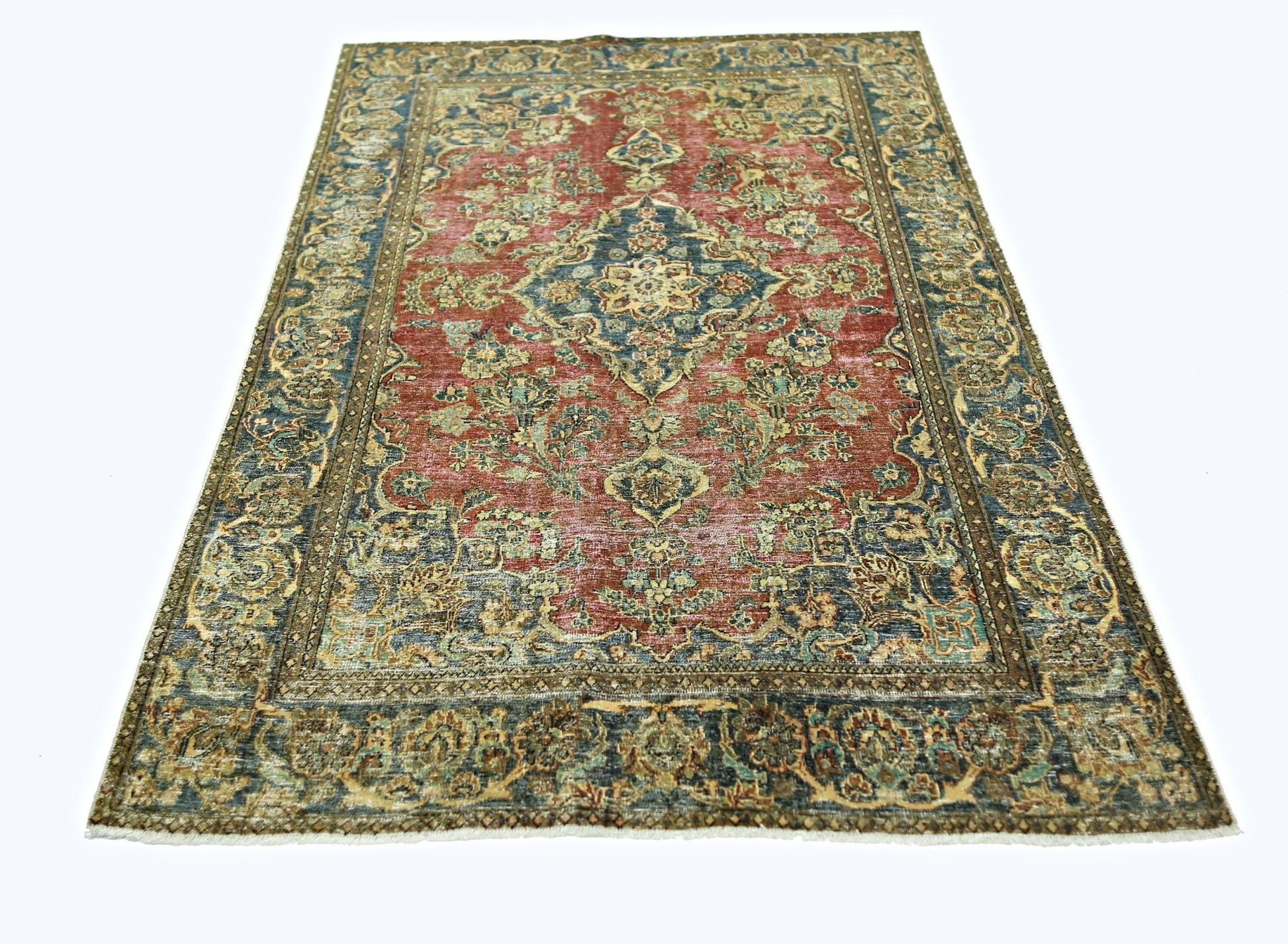 A vintage Persian rug featuring a central medallion and intricate floral patterns in red and blue.