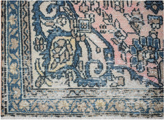 Vintage Persian rug with intricate blue and pink floral patterns.