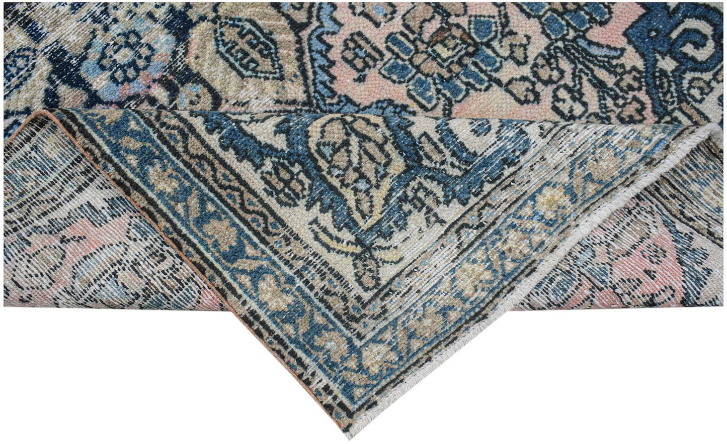 Vintage Persian rug with intricate blue, pink, and beige patterns.