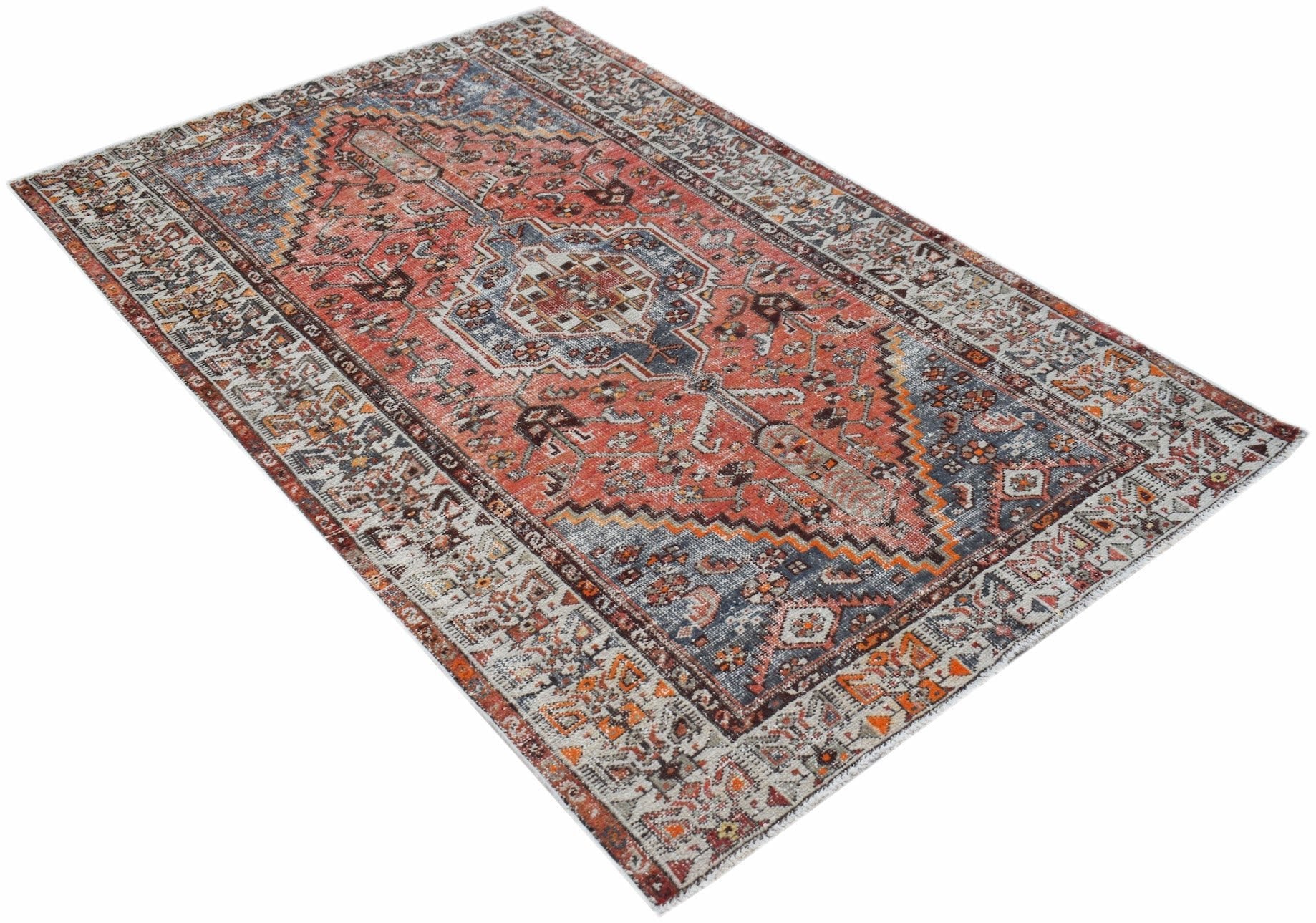 A rectangular vintage Persian rug featuring a traditional medallion pattern in red, blue, and grey.