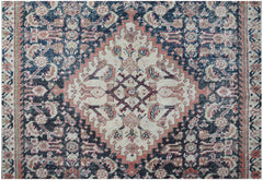 A vintage handwoven Persian rug featuring a central diamond medallion in cream, blue, and red.