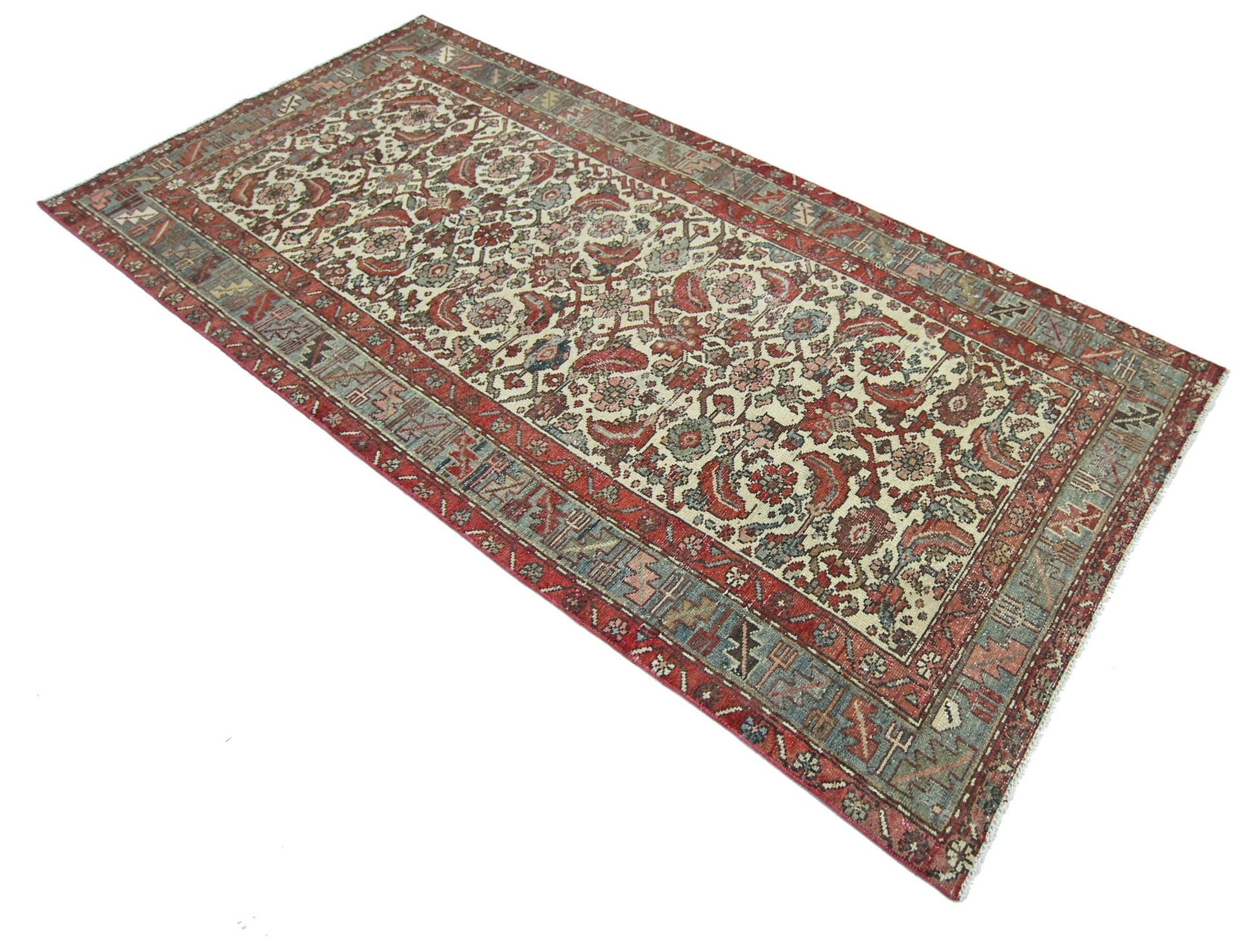A rectangular vintage Persian rug featuring a traditional floral pattern in red and blue tones.