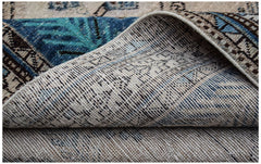 A handwoven vintage Persian rug with a blue and beige geometric pattern shown from the underside.