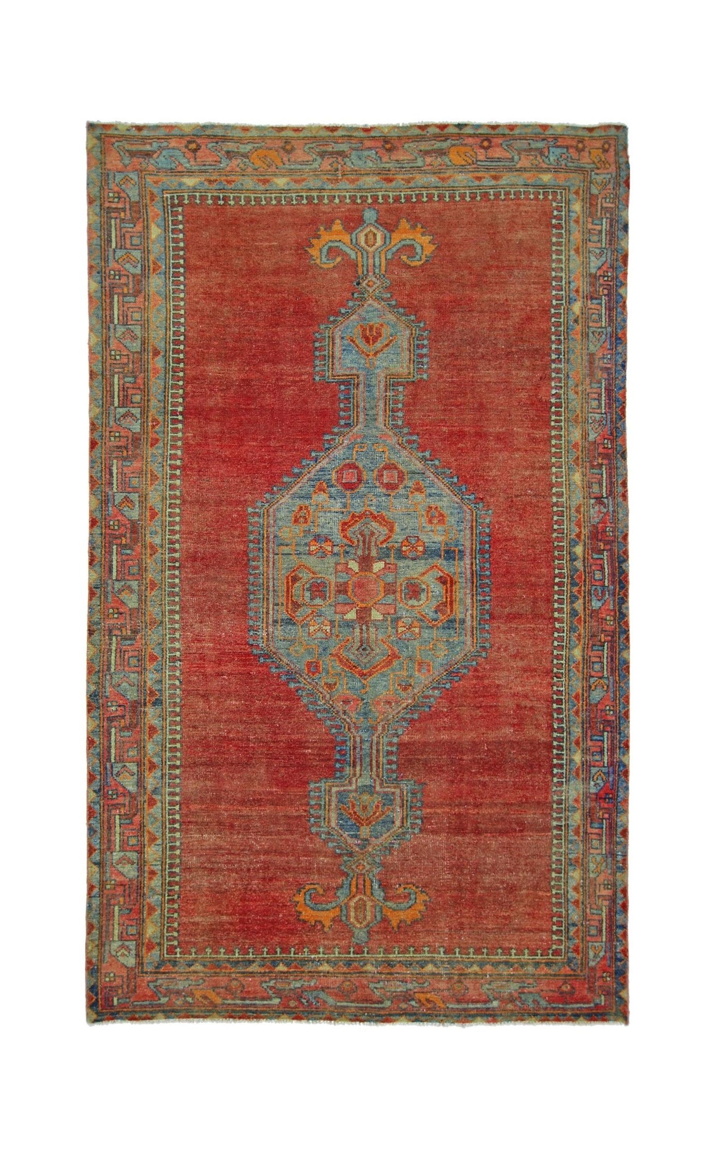 A vintage Persian rug featuring a central blue geometric medallion on a red field.