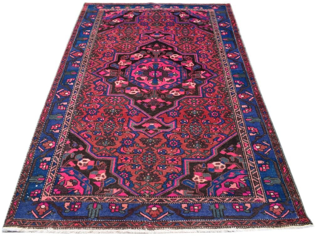 A rectangular vintage Persian rug featuring a central medallion with intricate floral patterns.