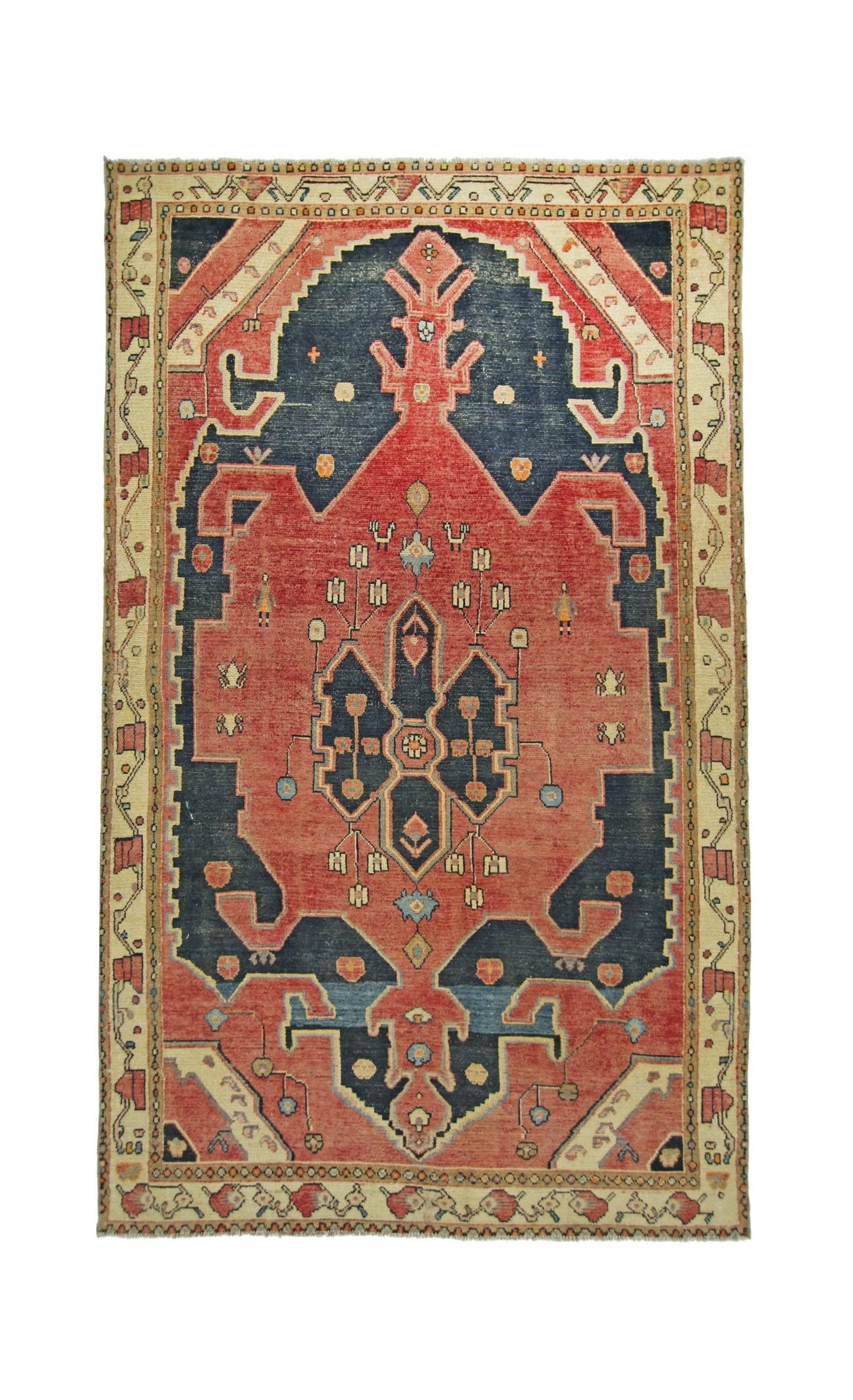 A vintage handmade Persian rug featuring a geometric medallion pattern in red and navy blue.