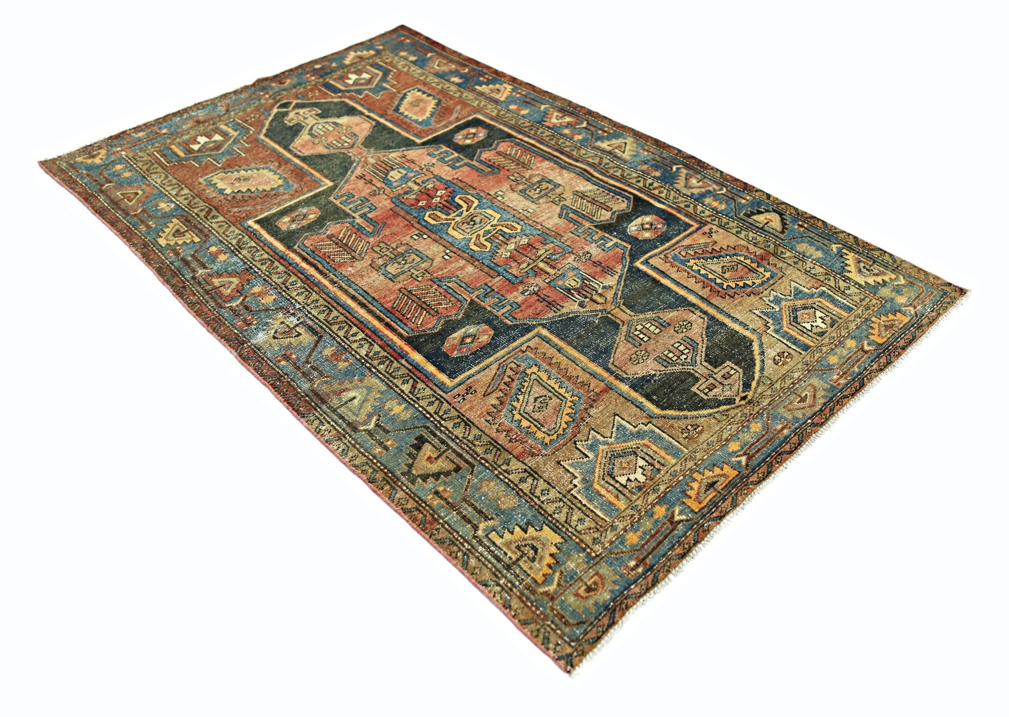 A rectangular vintage Persian rug featuring a geometric pattern in blue, red, and tan tones.