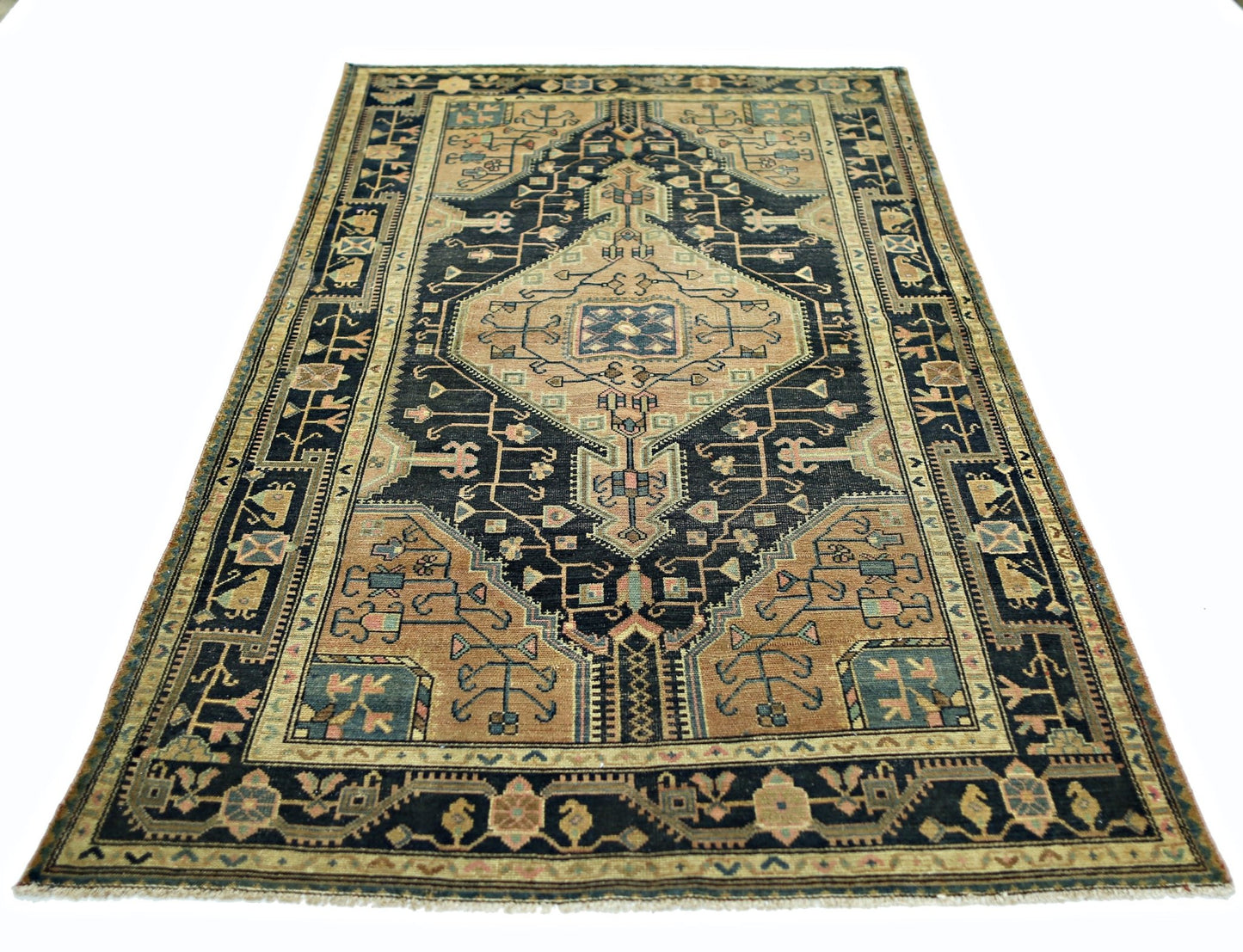 A vintage Persian rug featuring a geometric diamond medallion pattern in blue and tan tones.