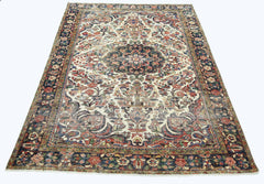 A vintage Persian rug featuring a central floral medallion on a cream field with a dark border.