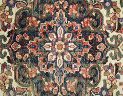 A vintage Persian rug featuring a detailed floral medallion pattern in red, blue, and green tones.