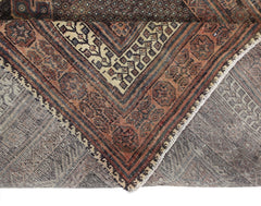 A corner view of a vintage handmade Persian rug featuring geometric patterns in rust and cream.