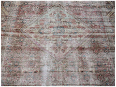 A vintage handwoven Persian rug featuring a faded diamond medallion pattern in muted tones.