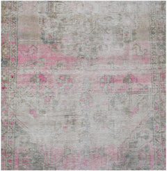 Vintage Persian rug with a distressed pink and grey pattern.