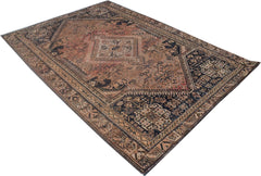 A rectangular handmade Persian wool rug featuring a traditional tribal pattern in rust and navy.