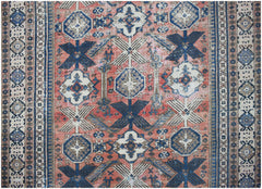 A vintage handwoven Persian rug featuring geometric patterns in shades of red, blue, and cream.