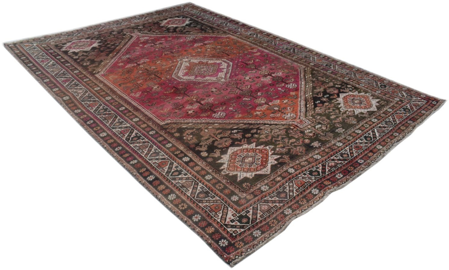 A handmade vintage Persian wool rug featuring a central medallion and intricate tribal patterns.