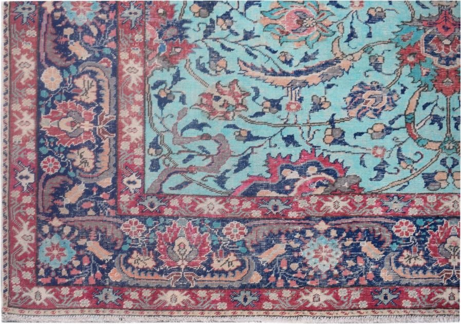 A vintage Persian rug featuring a light blue field with intricate floral patterns and red borders.