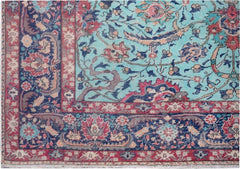 A vintage Persian rug featuring a light blue field with intricate floral patterns and red borders.