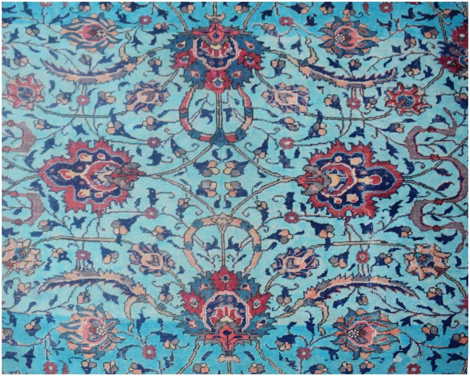 A vintage Persian rug featuring an intricate floral pattern in shades of blue, red, and cream.