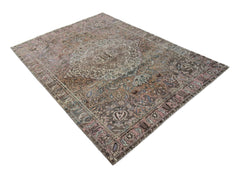 A vintage Persian rug featuring a faded floral medallion pattern in muted brown and pink tones.