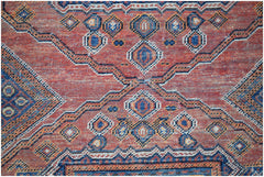 A vintage handwoven Persian rug featuring a geometric pattern in shades of red, blue, and orange.