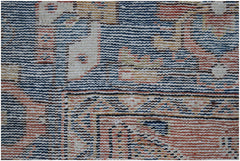 A close-up view of a handwoven vintage Persian rug featuring intricate geometric patterns.