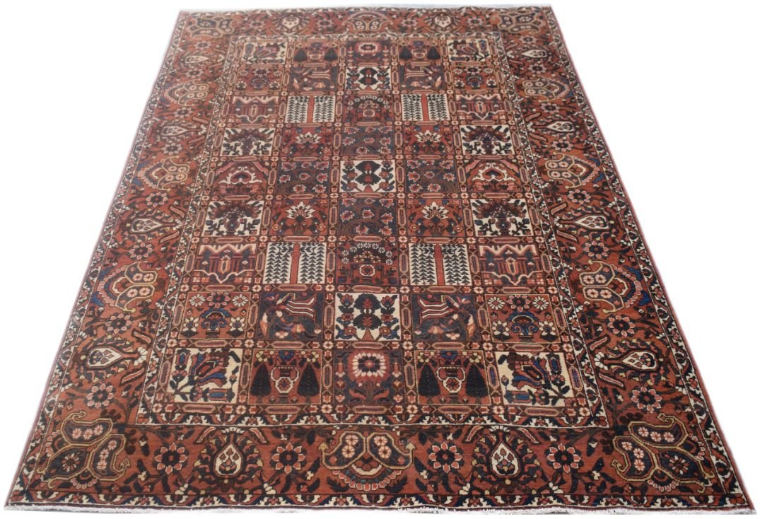 A rectangular vintage Persian rug featuring a geometric grid pattern in shades of red and blue.